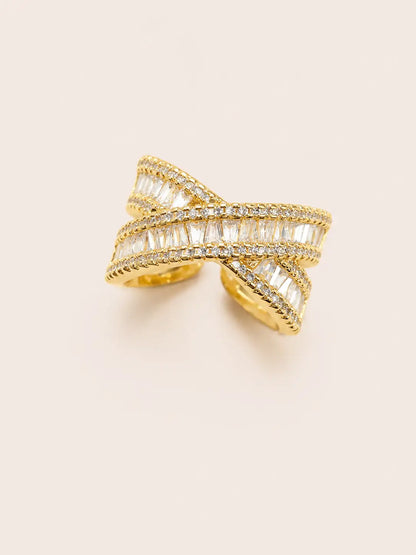 Gold ring with diamond accents on a light beige background